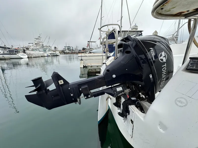 Slide: The Image of Catalina 250 MkII sailboat with Tohatsu outboard motor docked in a marina, 2005 model. - 6
