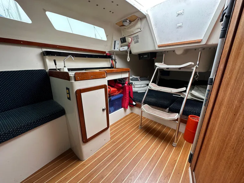 Slide: The Image of Interior of 2005 Catalina 250 MkII sailboat with compact kitchen and seating area. - 8