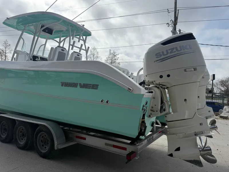 Slide: The Image of 2021 Twin Vee 310 GF boat with Suzuki outboard engine on trailer. - 10