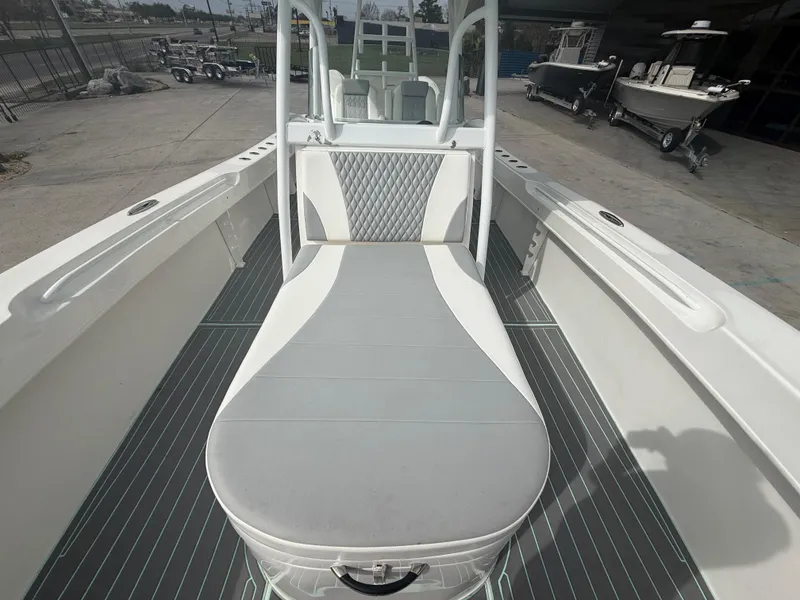 Slide: The Image of 2021 Twin Vee 310 GF boat interior with cushioned seating and sleek design. - 16