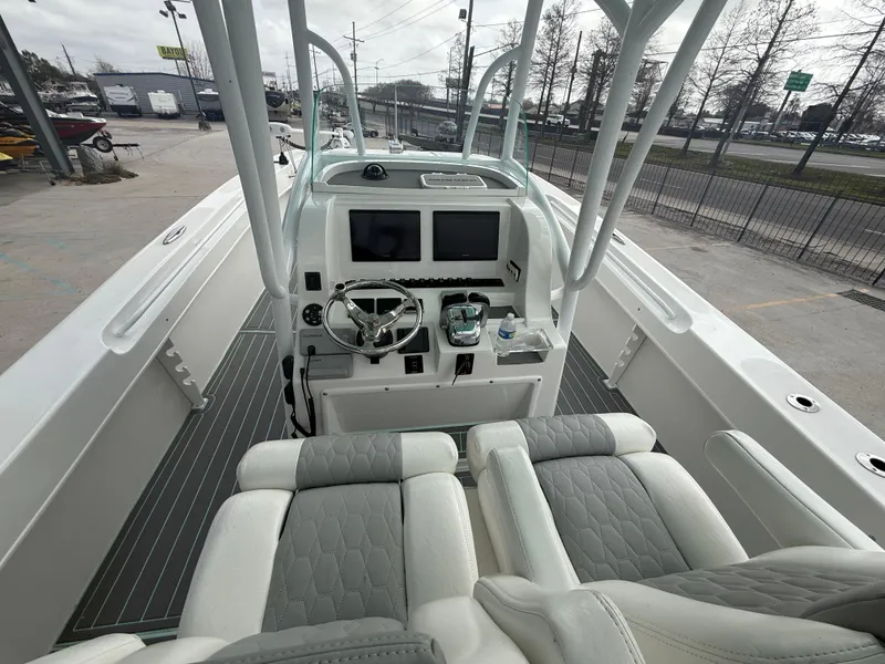 Slide: The Image of 2021 Twin Vee 310 GF boat interior with dual screens and cushioned seating. - 17