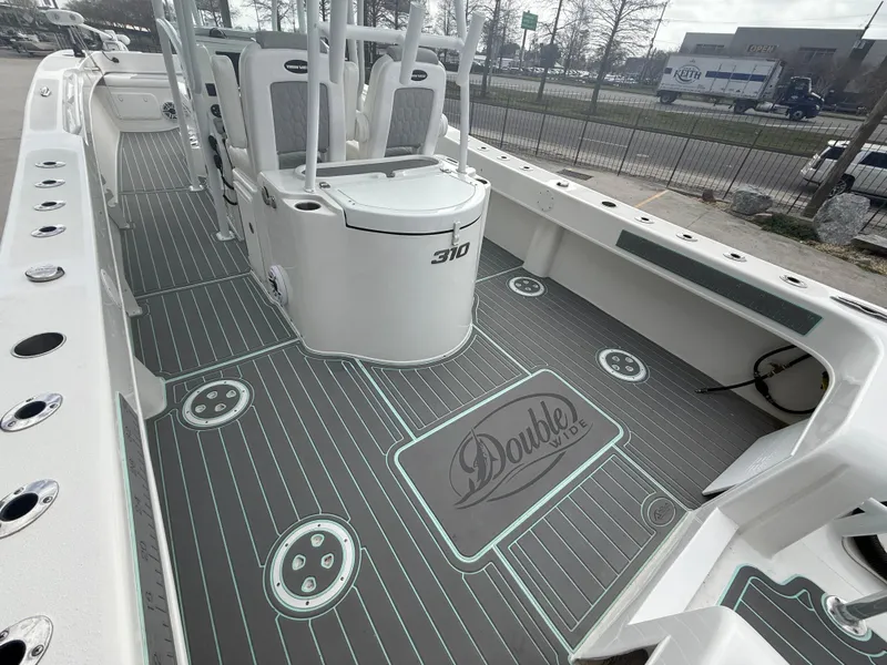 Slide: The Image of 2021 Twin Vee 310 GF boat interior with sleek gray flooring and seating. - 19