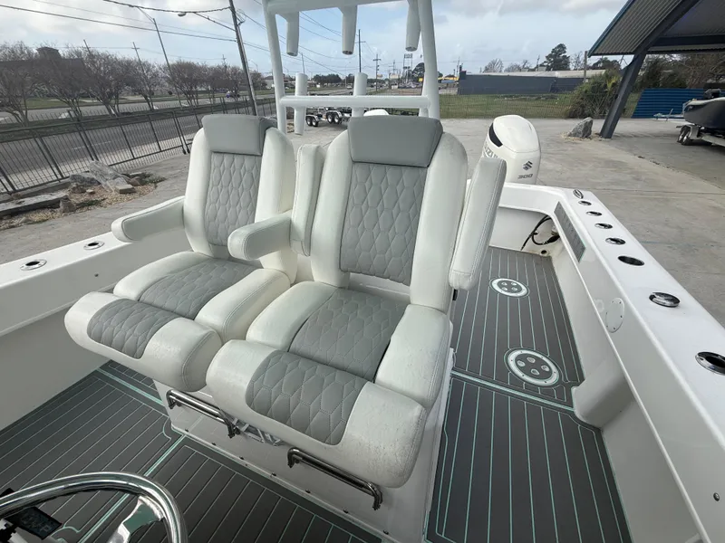 Slide: The Image of 2021 Twin Vee 310 GF boat interior with dual cushioned seats and modern design. - 21
