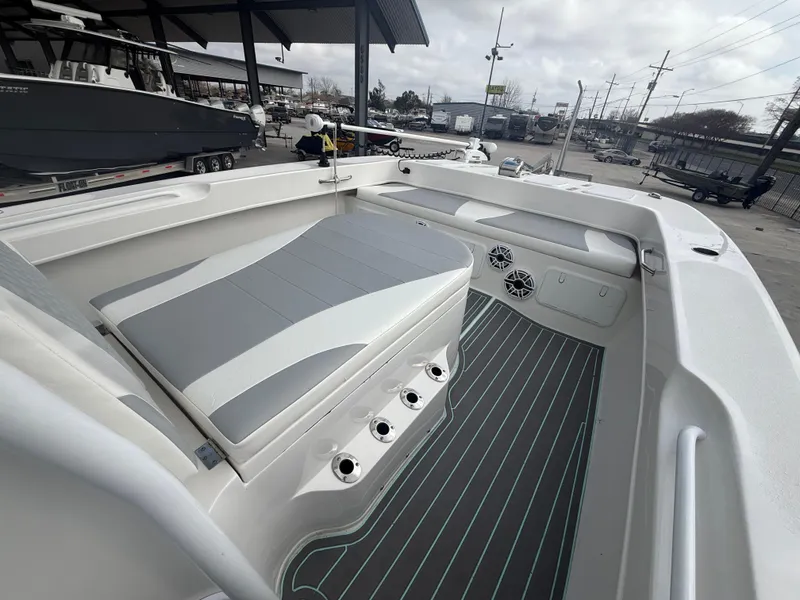 Slide: The Image of 2021 Twin Vee 310 GF boat interior with cushioned seating and rod holders. - 24
