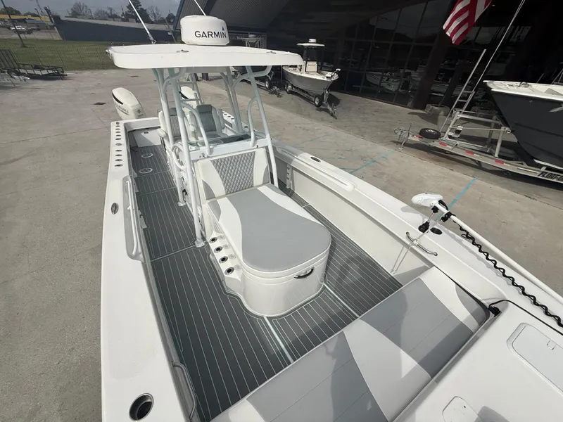 Slide: The Image of 2021 Twin Vee 310 GF boat with Garmin equipment, docked outdoors. - 25