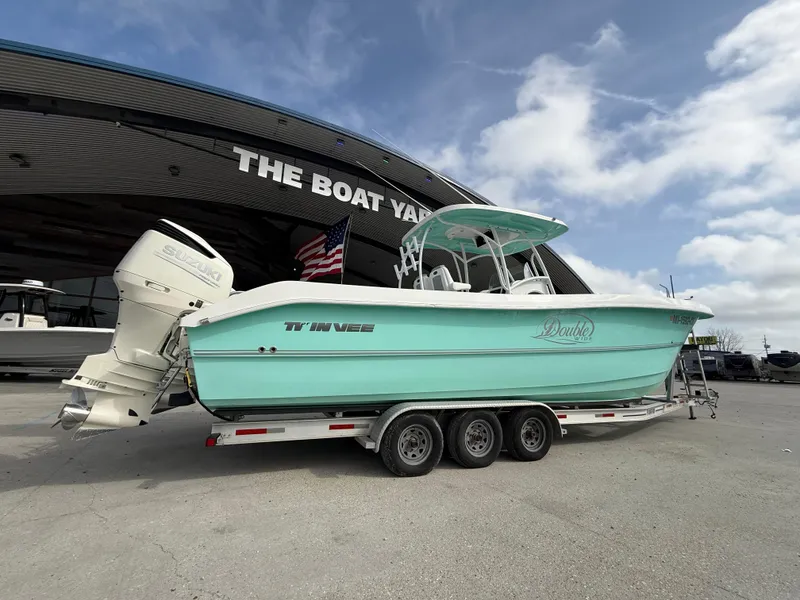 Slide: The Image of 2021 Twin Vee 310 GF boat on trailer at dealership, under clear sky. - 3