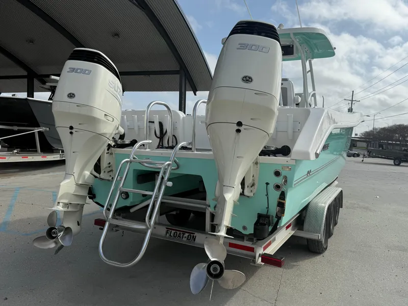 Slide: The Image of 2021 Twin Vee 310 GF boat with dual engines on a trailer. - 6