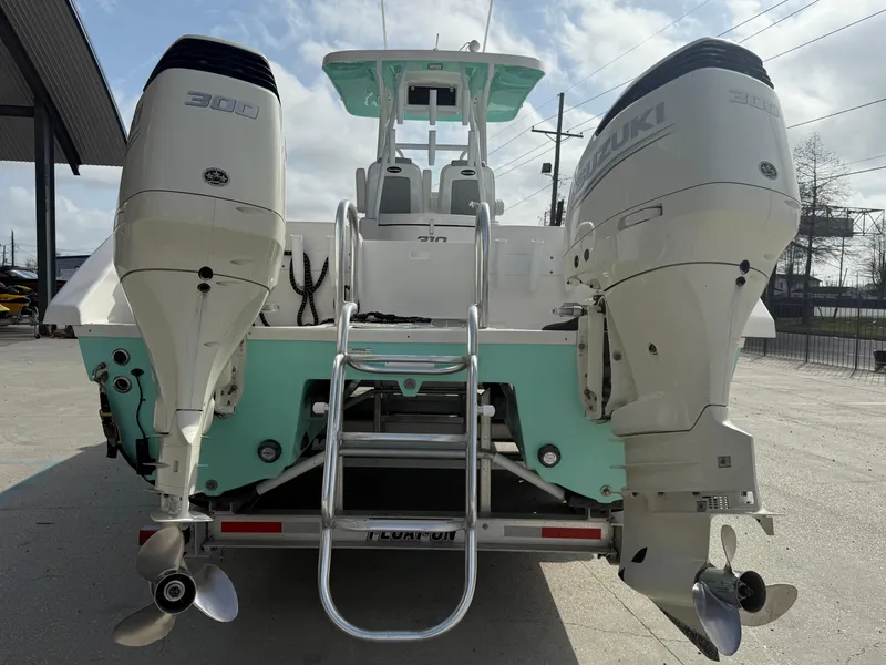 Slide: The Image of 2021 Twin Vee 310 GF boat with dual Suzuki outboard engines, rear view. - 8