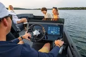 Slide: The Image of 2025 Manitou Explore boat with passengers enjoying a scenic lake ride. - 6