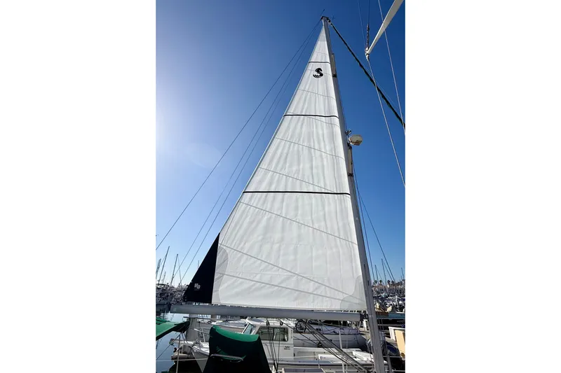 Slide: The Image of Sail of a 2001 Beneteau 411 yacht against a clear blue sky. - 14