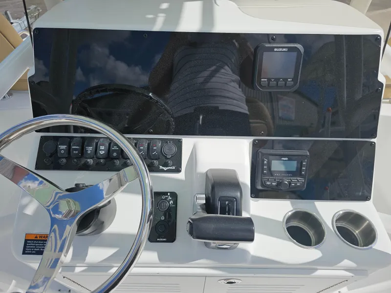 Slide: The Image of Control panel of 2025 Savannah 210X boat with steering wheel and electronic displays. - 10