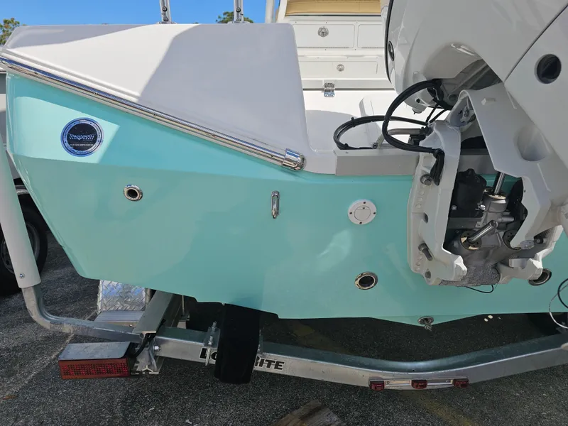Slide: The Image of 2025 Savannah 210X boat on trailer, featuring a light blue hull and outboard motor. - 11