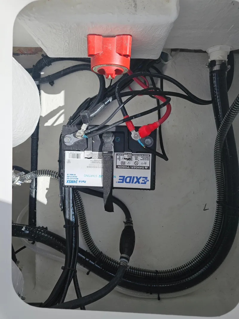 Slide: The Image of Battery compartment of 2025 Savannah 210X with Exide battery and wiring. - 16