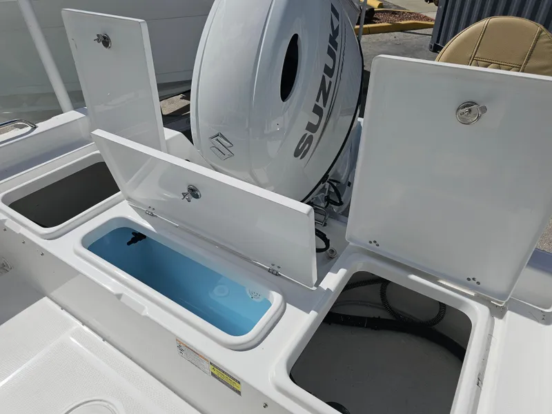 Slide: The Image of 2025 Savannah 210X boat with Suzuki engine and open storage compartments. - 18
