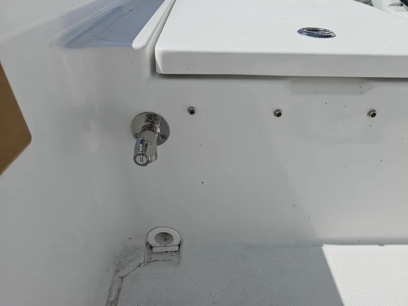 Slide: The Image of 2025 Savannah 210X boat interior detail with white seating and metal fixtures. - 20