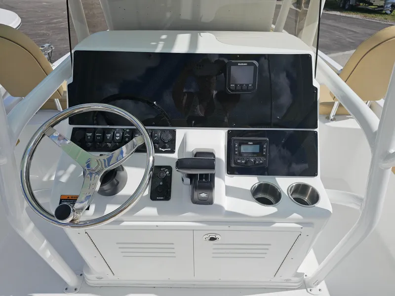 Slide: The Image of Control panel of 2025 Savannah 210X boat with steering wheel and navigation instruments. - 21