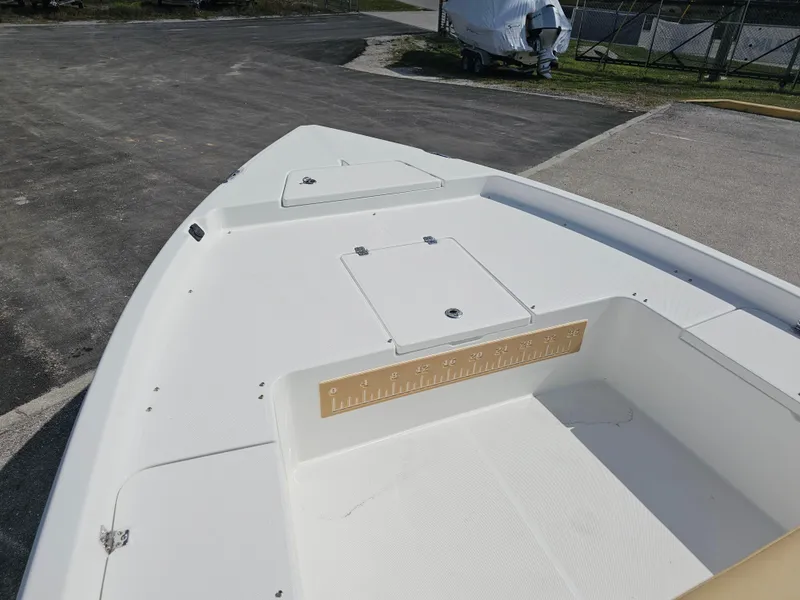 Slide: The Image of 2025 Savannah 210X boat deck, white surface, storage compartments, outdoor setting. - 23