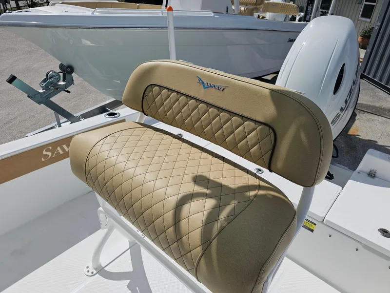 Slide: The Image of Savannah 210X 2025 boat seat with diamond-stitched upholstery and outboard motor. - 27