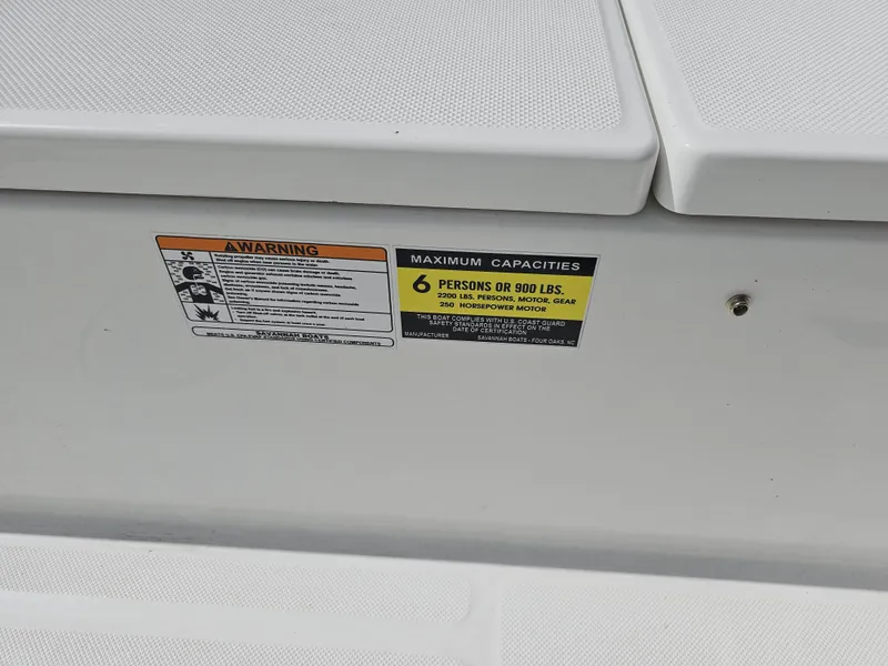 Slide: The Image of Capacity warning label on 2025 Savannah 210X boat, indicating 6 persons or 900 lbs. - 28