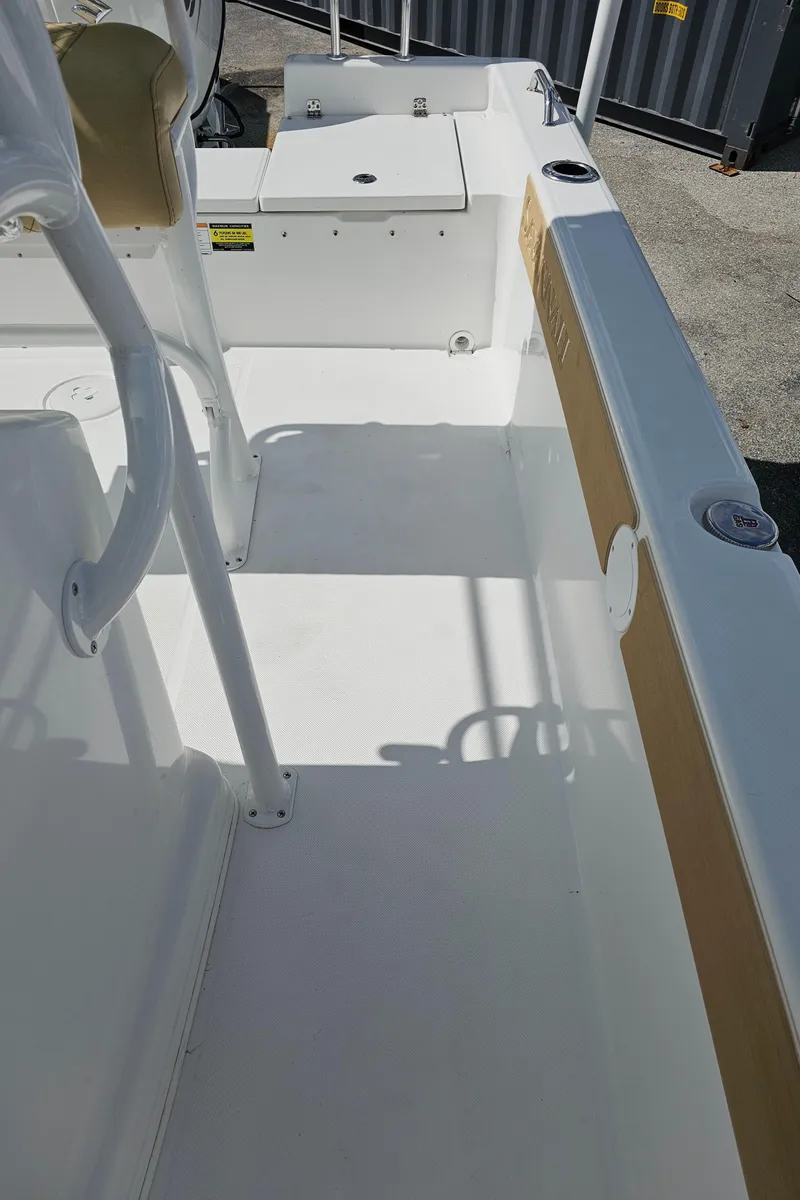 Slide: The Image of 2025 Savannah 210X boat interior, featuring white deck and seating area. - 33
