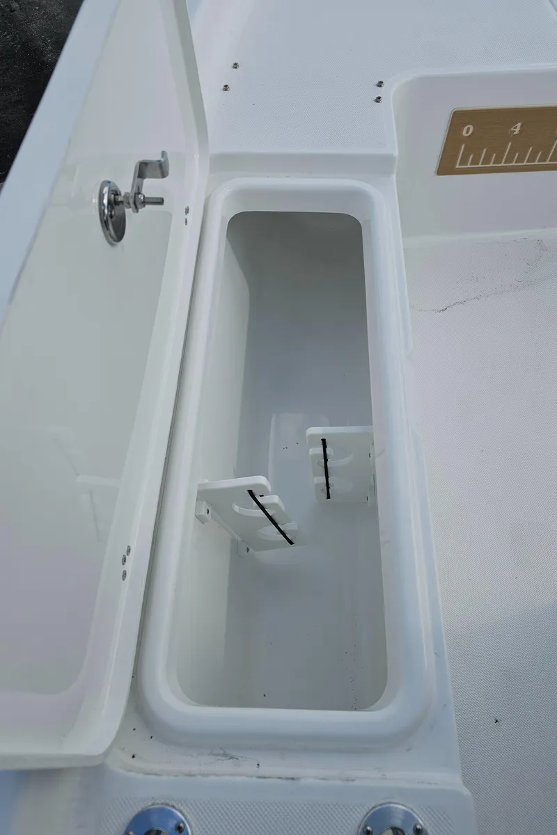Slide: The Image of Open storage compartment on a 2025 Savannah 210X boat deck. - 36