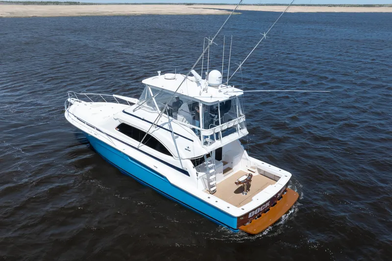 Slide: The Image of 2007 Bertram 570 Convertible yacht cruising on open water, showcasing sleek design and fishing equipment. - 10