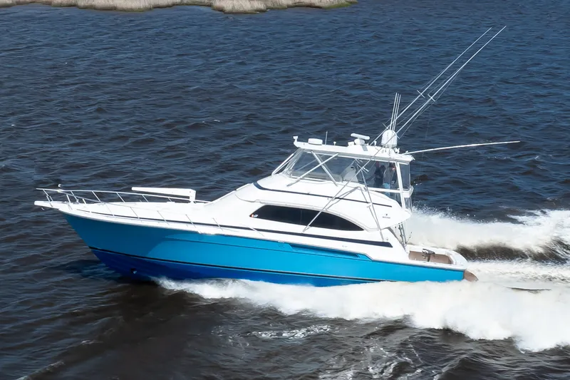 Slide: The Image of 2007 Bertram 570 Convertible yacht cruising on open water. - 12