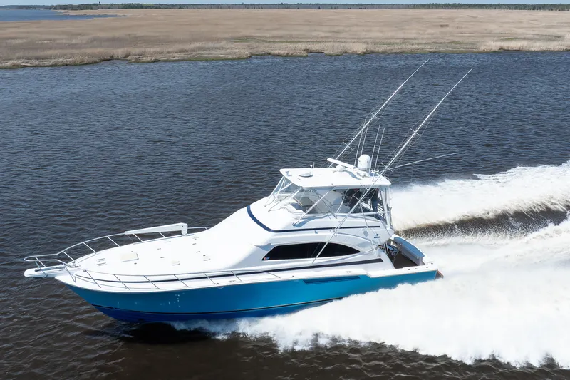 Slide: The Image of 2007 Bertram 570 Convertible yacht cruising on open water. - 13