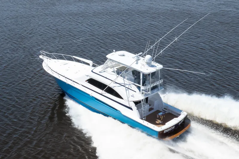 Slide: The Image of 2007 Bertram 570 Convertible yacht cruising on open water, showcasing sleek design and performance. - 14