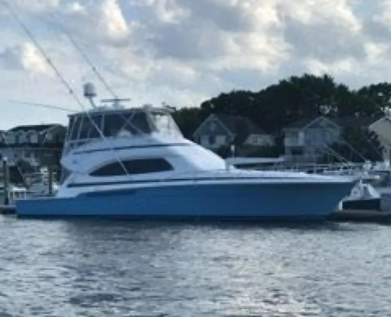 Slide: The Image of 2007 Bertram 570 Convertible yacht docked by waterfront homes. - 19