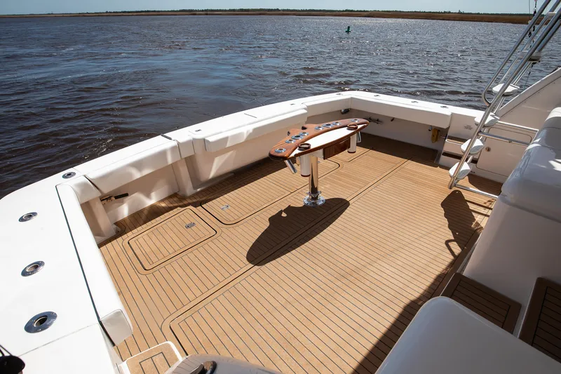 Slide: The Image of 2007 Bertram 570 Convertible yacht deck with wooden flooring and fishing rod holders. - 20