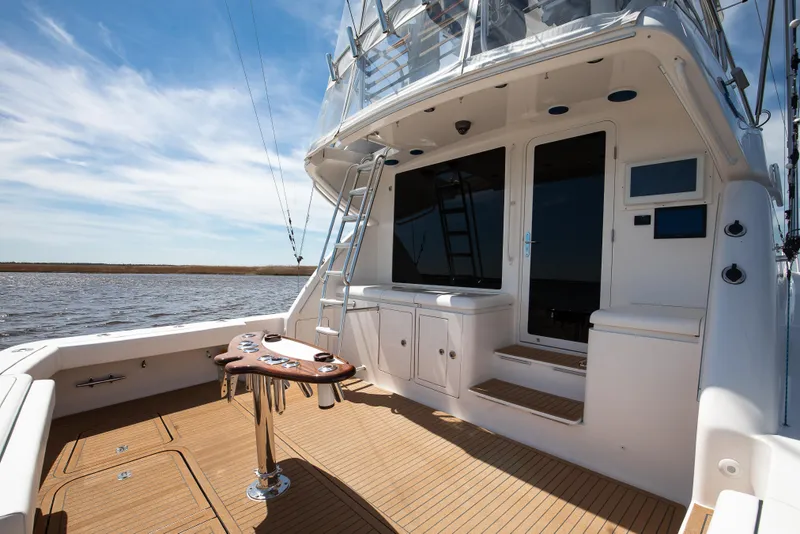 Slide: The Image of 2007 Bertram 570 Convertible yacht deck with fishing setup and ocean view. - 21