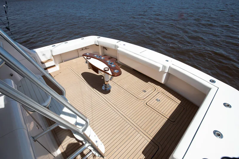 Slide: The Image of 2007 Bertram 570 Convertible yacht deck with wooden flooring and ocean view. - 23