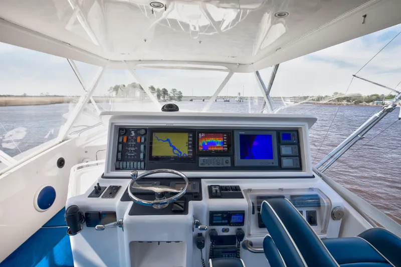 Slide: The Image of 2007 Bertram 570 Convertible yacht helm with advanced navigation systems and panoramic water view. - 24
