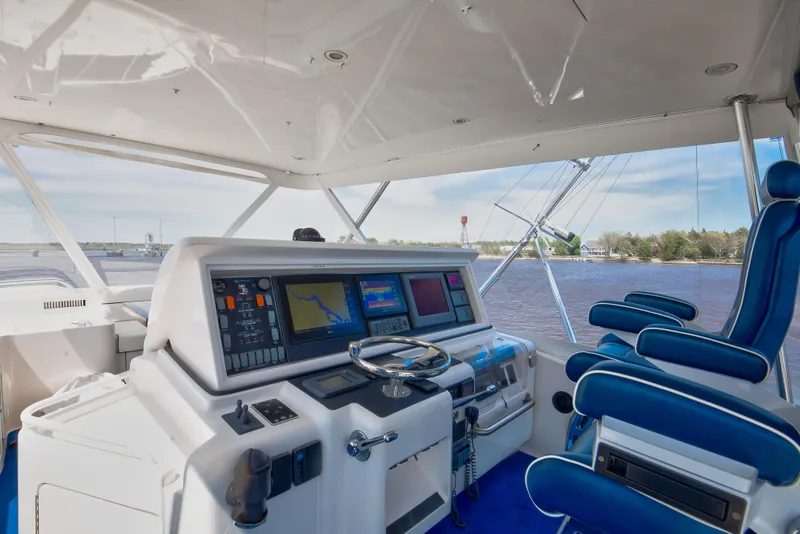 Slide: The Image of 2007 Bertram 570 Convertible yacht cockpit with navigation equipment and blue seating. - 26