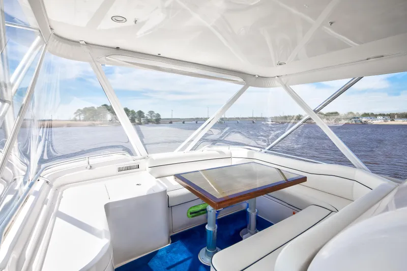 Slide: The Image of Interior view of 2007 Bertram 570 Convertible yacht with panoramic windows and elegant seating area. - 27