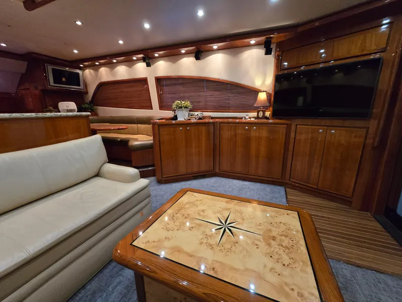 Slide: The Image of 2007 Bertram 570 Convertible yacht cruising on open water under clear blue sky. - 3