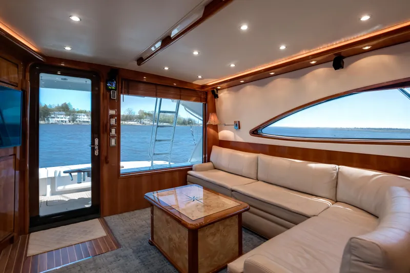 Slide: The Image of Luxurious interior of 2007 Bertram 570 Convertible yacht with plush seating and scenic water view. - 30