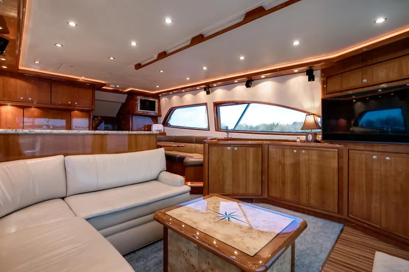 Slide: The Image of Luxurious interior of a 2007 Bertram 570 Convertible yacht with elegant wood finishes. - 31