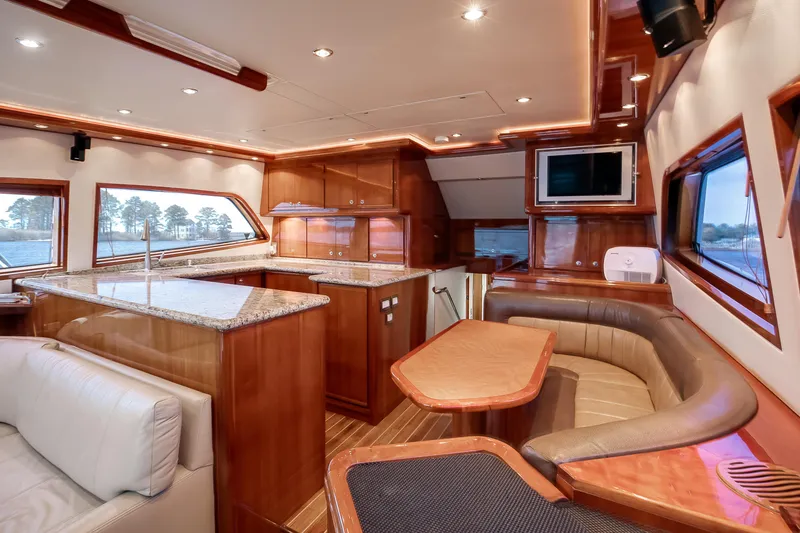 Slide: The Image of Luxurious interior of a 2007 Bertram 570 Convertible yacht with elegant wood finishes. - 32