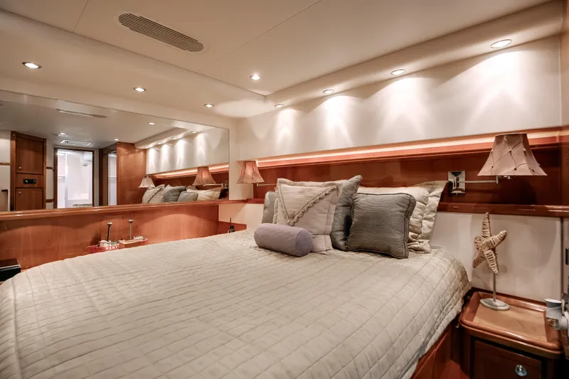 Slide: The Image of Luxurious bedroom interior of 2007 Bertram 570 Convertible yacht with elegant lighting and decor. - 38