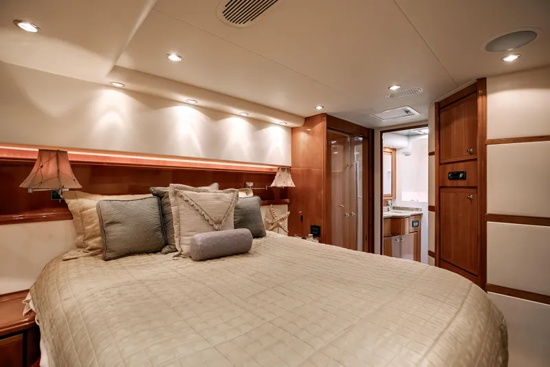 Slide: The Image of Luxurious bedroom interior of 2007 Bertram 570 Convertible yacht with elegant lighting and wood finishes. - 39
