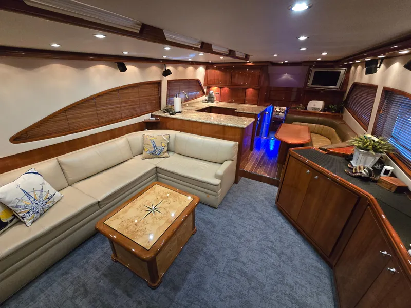 Slide: The Image of 2007 Bertram 570 Convertible yacht cruising on open water under clear blue sky. - 4