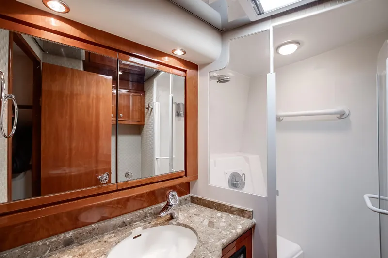 Slide: The Image of Luxurious bathroom interior of 2007 Bertram 570 Convertible yacht with elegant wood finishes. - 40