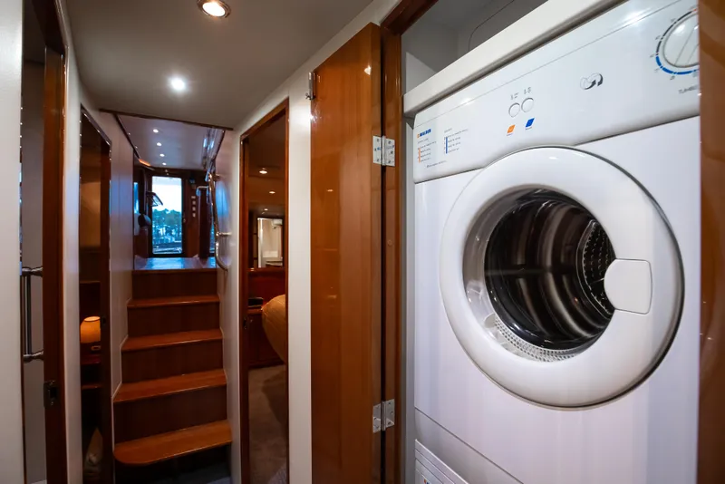 Slide: The Image of Interior of 2007 Bertram 570 Convertible yacht with washer and wooden stairs. - 42