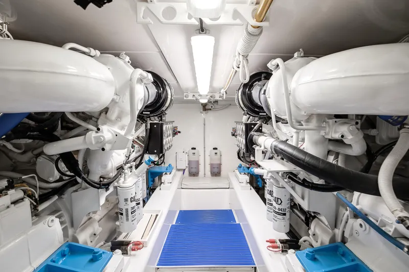 Slide: The Image of Engine room of a 2007 Bertram 570 Convertible yacht, featuring dual engines and clean layout. - 44