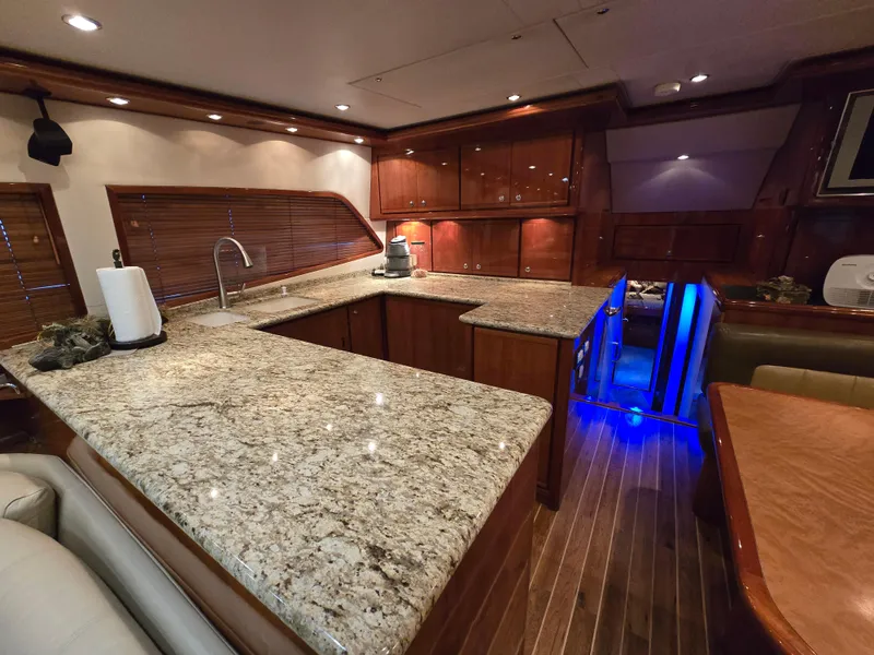 Slide: The Image of 2007 Bertram 570 Convertible yacht on open water under clear blue sky. - 6