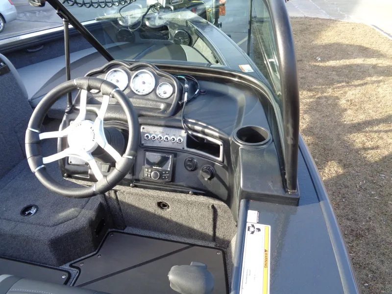 Slide: The Image of 2025 Lund 1875 Crossover XS boat dashboard with steering wheel and instrument panel. - 10