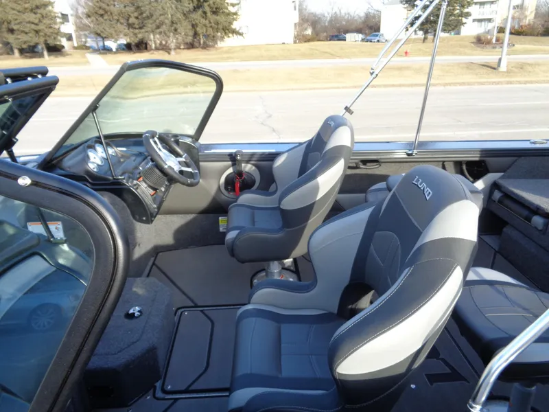 Slide: The Image of 2025 Lund 1875 Crossover XS boat interior with modern seating and steering wheel. - 3