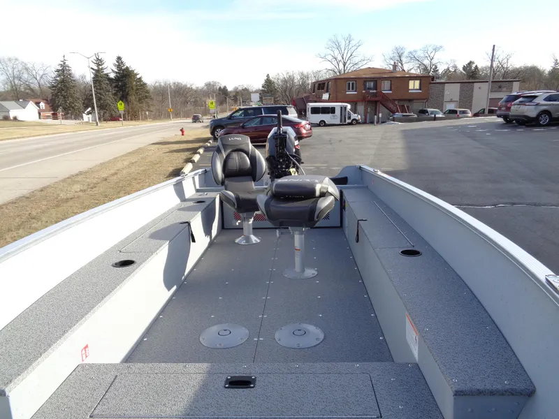 Slide: The Image of 2025 Lund 1600 Fury Heritage boat with seating, parked in a lot. - 10